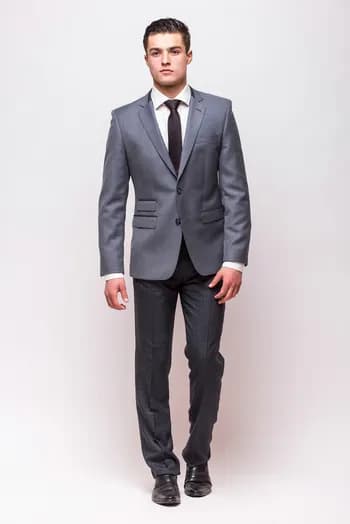 https://backend.antailors.ae/wp-content/uploads/2025/05/full-length-portrait-businessman-isolated-gray-wall.webp